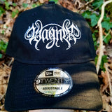 Black baseball cap with a heavy metal style logo for the classical music composer Wagner embroidered on the front in white thread.