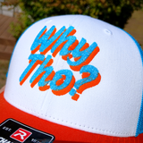 Close up view of a white, blue, and orange trucker style hat with blue and orange embroidery spelling out the phrase, why though?