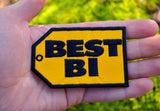 Yellow and black embroidered parody patch resembling the best buy logo that says best bi instead. Shown in the palm of a hand for size reference.