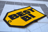 Close up detail of a yellow and black embroidered parody patch resembling the best buy logo that says best bi instead.