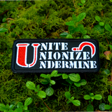 Rectangular black embroidered patch with the words unite, unionize, undermine written in a stencil font, featuring a red sickle.