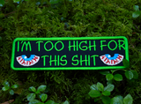 Rectangular green-bordered embroidered patch with a pair of bloodshot eyes and the text, I'm too high for this shit in green thread.
