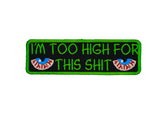 Rectangular green-bordered embroidered patch with a pair of bloodshot eyes and the text, I'm too high for this shit in green thread.