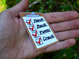 An embroidered patch of a clipboard with red checkmarks next to the words neck, back, pussy, and crack. Shown in the palm of a hand for size reference.
