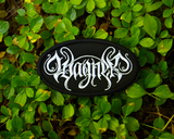 Oval-shaped black embroidered patch with the name of the classical music composer Wagner stylized in white thread to resemble a heavy metal band logo.