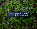 Rectangular black embroidered patch with a quote by Bonecrusher in white thread that says I hate people, man.