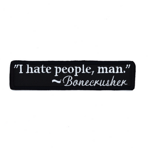 Rectangular black embroidered patch with a quote by Bonecrusher in white thread that says I hate people, man.