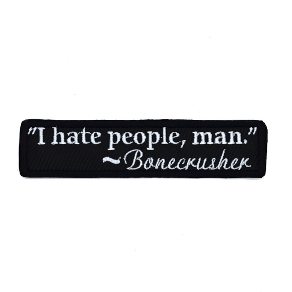 Rectangular black embroidered patch with a quote by Bonecrusher in white thread that says I hate people, man.