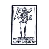 Rectangular black and white embroidered patch of a smoking skeleton in a medieval woodcut design style with the phrase doeth whatever spelled out in old English lettering.