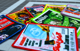 Close up detail of a collection of printed patches with embroidered borders featuring theatrical poster art from classic horror and sci-fi movies from the 1930s to the 1960s.