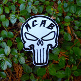 Black and white embroidered Punisher symbol patch with the letters a, c, a, b across the forehead.