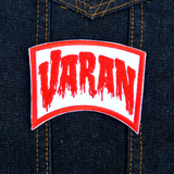 Red and white embroidered logo patch for the classic Kaiju giant monster movie, Varan, the Unbelievable. Shown on denim jacket.