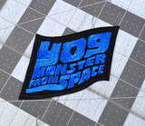 Blue and black embroidered logo patch for the classic kaiju monster movie, Yog, Monster from Space.