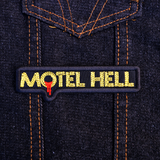 Rectangular black and yellow embroidered logo patch for the classic comedy horror slasher movie Motel Hell.