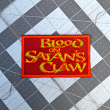 Rectangular red patch with textured yellow text 'Blood on Satan's Claw', inspired by the classic folk horror movie.