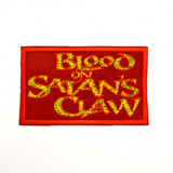 Rectangular red patch with textured yellow text 'Blood on Satan's Claw', inspired by the classic folk horror movie.