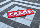 Close up detail of a rectangular red bordered embroidered patch on white fabric with the word chaos carved out of a web of random lines of red thread.