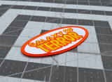 Close up detail of an oval-shaped white, orange, and yellow embroidered patch made from the title logo of the cult classic sci-fi horror movie Galaxy of Terror.