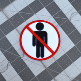 Circular white embroidered patch with red border and a red line crossing out a black silhouette of a person, resembling a public sign.