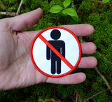 Circular white embroidered patch with red border and a red line crossing out a black silhouette of a person, resembling a public sign. Shown in the palm of a hand for size reference.