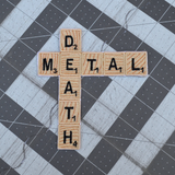 Embroidered patch resembling wooden scrabble tiles spelling the words 'DEATH METAL'.