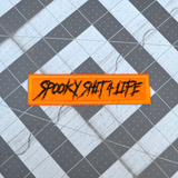 Rectangular orange embroidered patch with the text, spooky shit 4 life, stitched in black thread.
