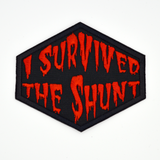 Red on black embroidered patch that says I survived the shunt, in reference to the horror movie, Society.