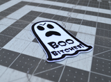 Close up detail of a black and white embroidered patch of an angry ghost with text that says 'Boo Bitches!'.