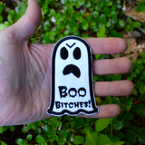 Black and white embroidered patch of an angry ghost with text that says 'Boo Bitches!'. Shown in the palm of a hand for size reference.