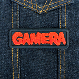 Black rectangular embroidered patch with the name Gamera in red thread, based on the classic Japanese Kaiju monster movie.