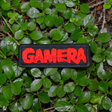 Black rectangular embroidered patch with the name Gamera in red thread, based on the classic Japanese Kaiju monster movie.