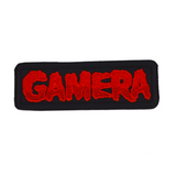 Black rectangular embroidered patch with the name Gamera in red thread, based on the classic Japanese Kaiju monster movie.