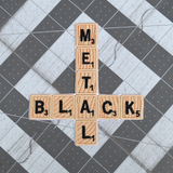An embroidered patch that says black metal spelled out in Scrabble letters in the shape of an inverted cross.