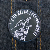 Circular white on black embroidered patch of a raven screaming, I said never-fucking-more!