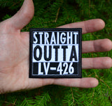 Square black and white embroidered patch that says straight outta LV-426. Shown in the palm of a hand for size reference.