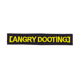 Rectangular black embroidered patch with yellow lettering that says angry dooting, resembling a movie subtitle.