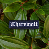 Black rectangular embroidered patch with the word 'therewolf' stitched with white thread in Old English lettering.