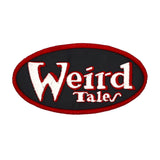 Oval shaped embroidered patch on black fabric, a red border and the logo for the classic strange fiction magazine, Weird Tales stitched in white and red.