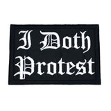A rectangular black embroidered patch with white Gothic lettering that reads 'I Doth Protest'.