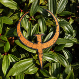 A large rust colored embroidered patch of the logo for the Quake 1 video game.