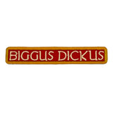 An embroidered rectangular patch with the text 'BIGGUS DICKUS' in cream lettering on a red background, bordered in gold.