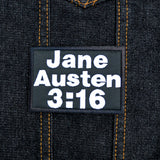 Rectangular black embroidered patch with white block lettering that says, 'Jane Austen 3:16".