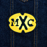 A black and yellow oval-shaped logo patch for the comedy tv show MXC.