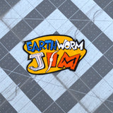 An embroidered patch made from the logo of the classic platformer video game Earthworm Jim.