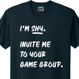 A dark navy colored shirt with the words, I'm shy, invite me to your game group, printed one the front in white.