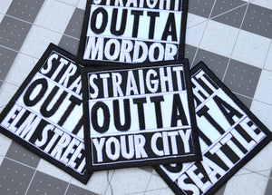 A collection of square shaped white and black embroidered patches in the Straight Outta Compton format that can be customized with personal text.