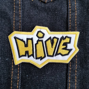 Embroidered logo patch for the abstract boardgame Hive in yellow and black.